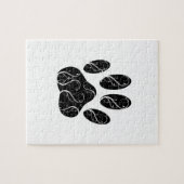 Zwarte hondenpootafdruk met witte krullen legpuzzel (Horizontaal)