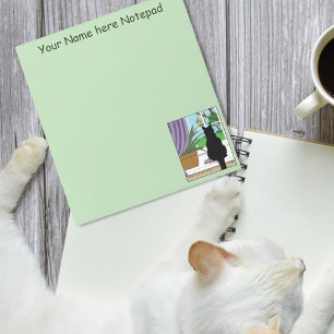 Zwarte kat die uit venster kijkt notitieblok