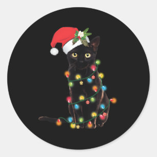 Zwarte kat kerstman verstrikt in lichten ronde sticker