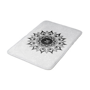 Zwarte mandala op een witte paisley badmat