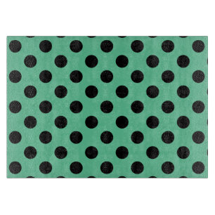 Zwarte polka-punten op muntgroen snijplank