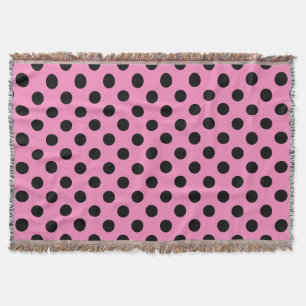 Zwarte polka-stippen op roze deken