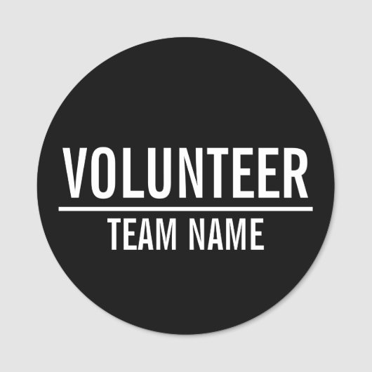 Zwarte Volunteer Badge met de naam van het Team va (Voorkant)